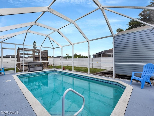 view of swimming pool with a lanai, a fenced in pool, a patio, and fence