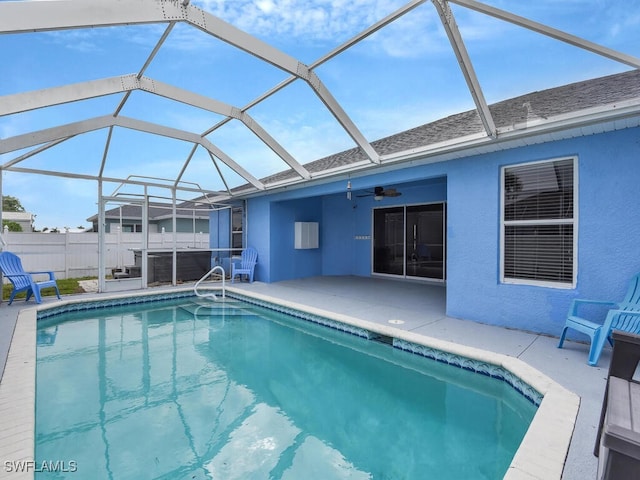 view of pool featuring a patio area, a fenced in pool, glass enclosure, and fence