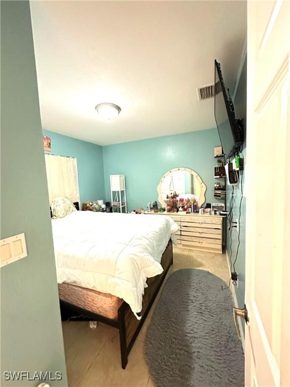 bedroom featuring light tile patterned floors