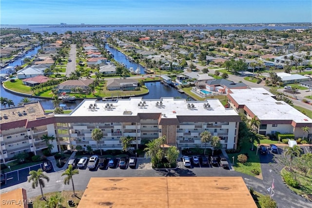 drone / aerial view with a water view and a residential view