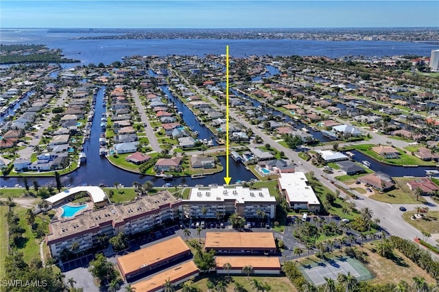 drone / aerial view featuring a water view and a residential view