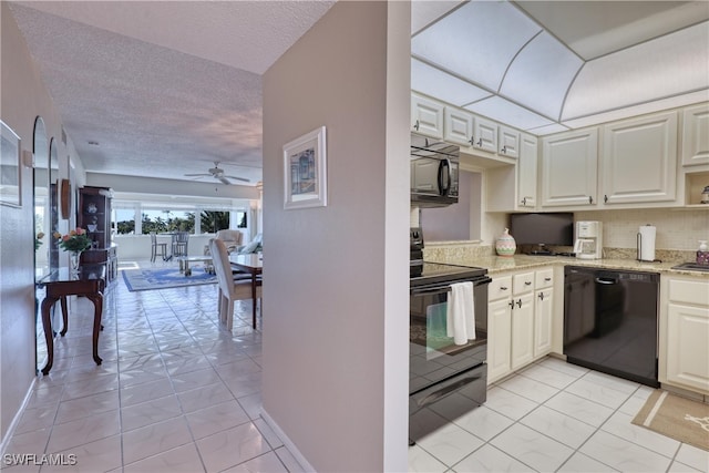 kitchen with black appliances, a ceiling fan, light stone counters, a textured ceiling, and baseboards