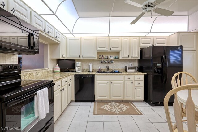 kitchen with decorative backsplash, black appliances, a ceiling fan, and a sink