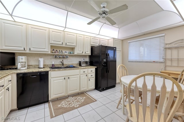 kitchen with black appliances, a ceiling fan, a sink, backsplash, and white cabinetry