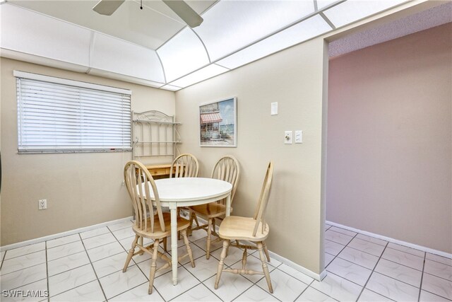 dining area with marble finish floor, baseboards, and a ceiling fan