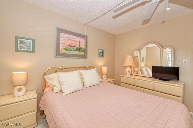 bedroom with a textured ceiling and ceiling fan