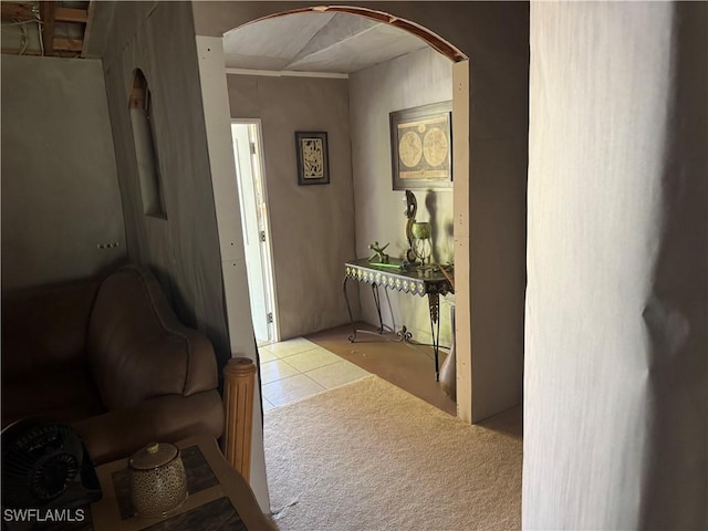 hallway with tile patterned flooring and arched walkways