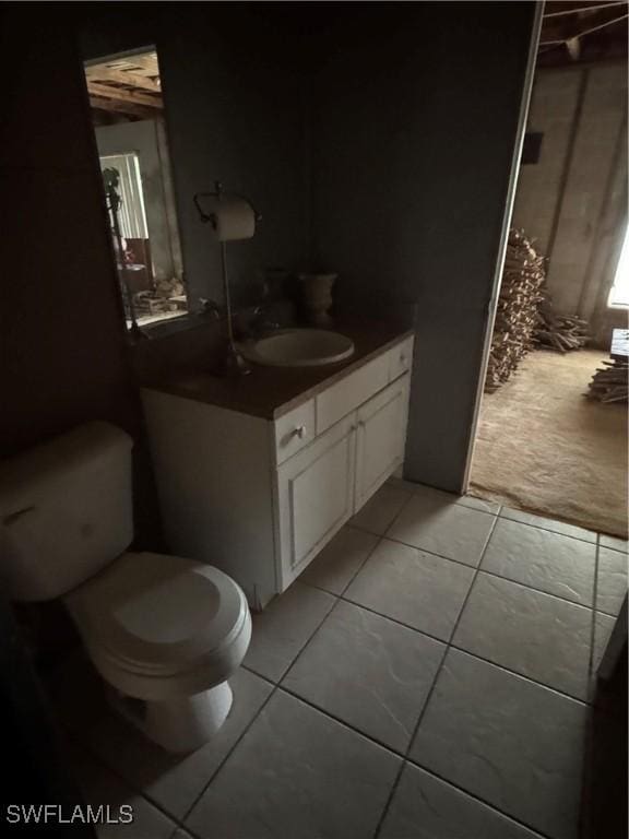 bathroom with tile patterned floors, toilet, and vanity