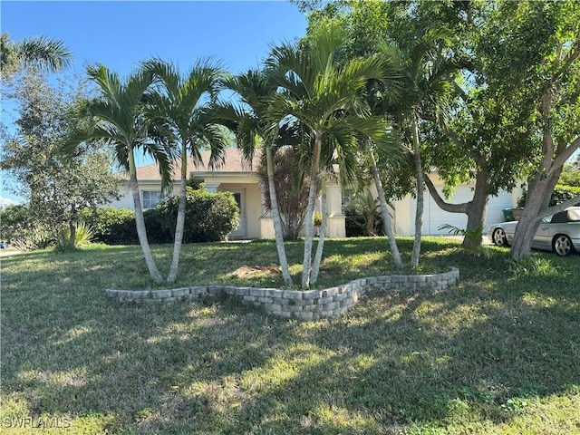 view of front of house featuring a garage and a front lawn