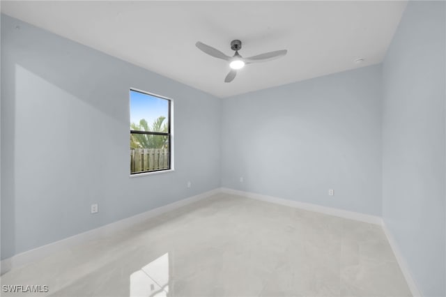 unfurnished room with baseboards and ceiling fan