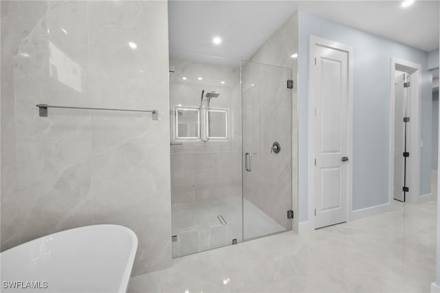 full bathroom featuring recessed lighting, a marble finish shower, a soaking tub, and marble finish floor