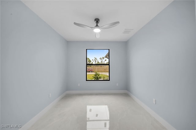 unfurnished room featuring baseboards, visible vents, and ceiling fan