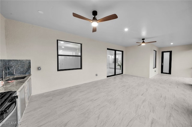 empty room with a sink, ceiling fan, and recessed lighting