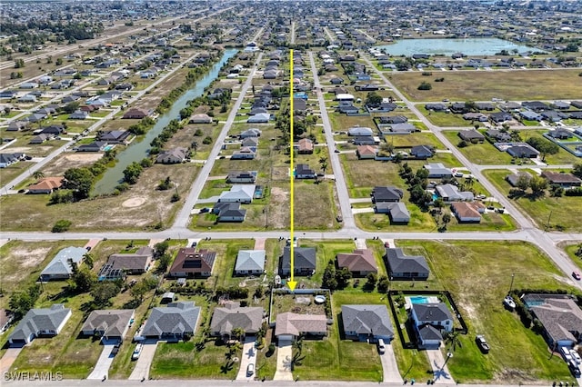 drone / aerial view featuring a residential view and a water view