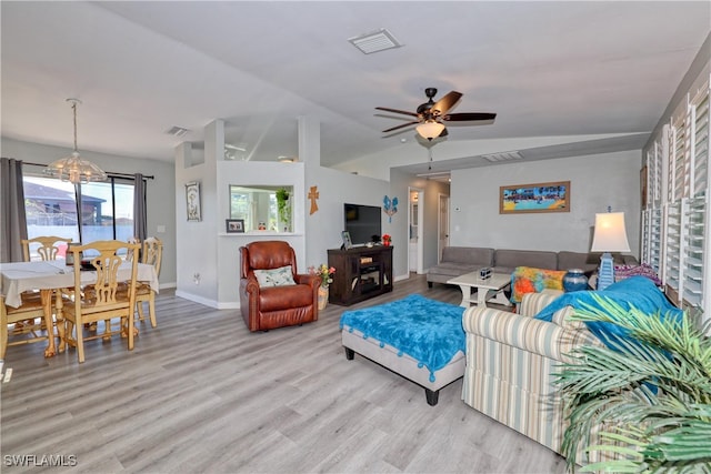 living area featuring visible vents, ceiling fan with notable chandelier, and light wood-style floors