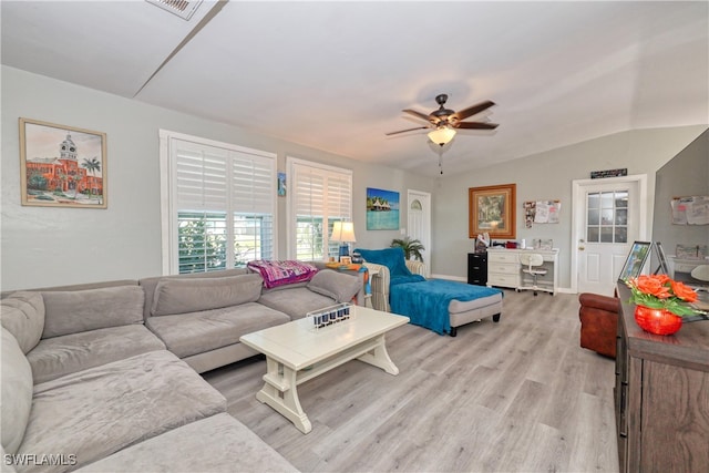 living room featuring vaulted ceiling, light wood-style flooring, visible vents, and ceiling fan