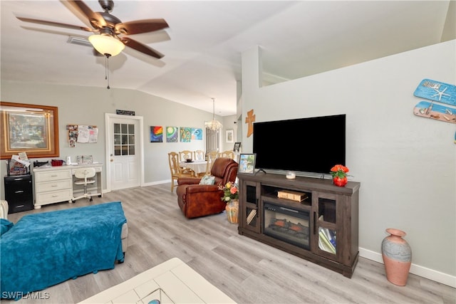 living room with lofted ceiling, wood finished floors, ceiling fan with notable chandelier, and baseboards