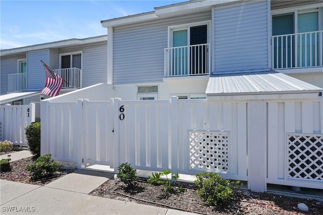 exterior space with board and batten siding and a fenced front yard