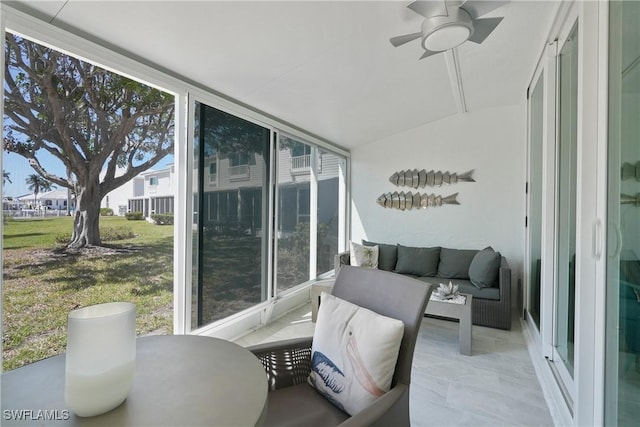 sunroom / solarium featuring a ceiling fan