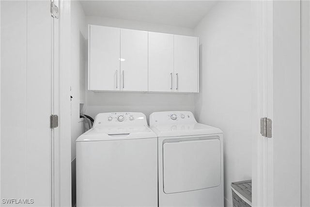 laundry area with cabinet space and washing machine and dryer