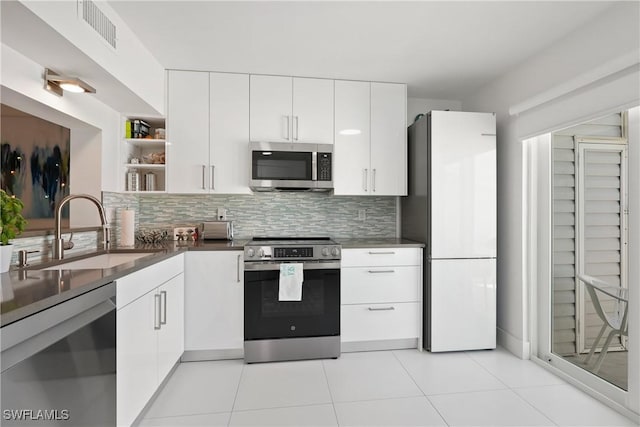 kitchen featuring visible vents, open shelves, a sink, appliances with stainless steel finishes, and white cabinetry