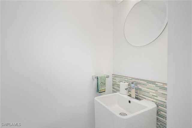 bathroom with tile walls and a sink