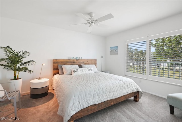 carpeted bedroom featuring a ceiling fan and baseboards