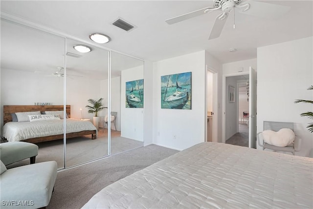 bedroom with visible vents, carpet floors, a closet, and ceiling fan