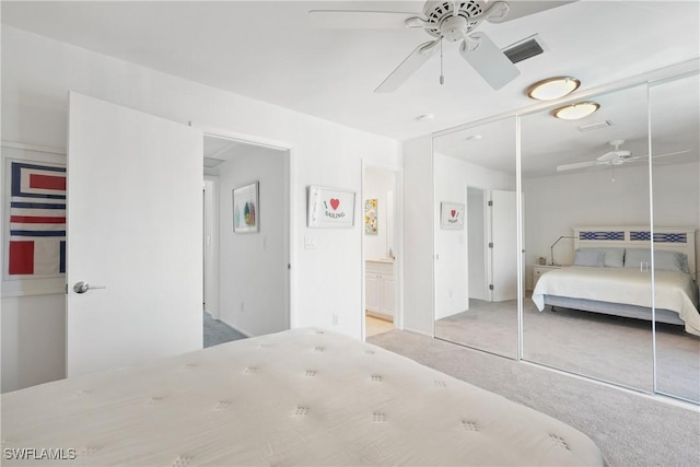 bedroom featuring a closet, visible vents, ceiling fan, and carpet floors