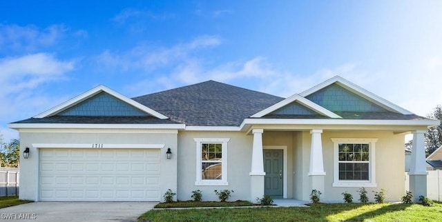 view of front of home with a shingled roof, an attached garage, driveway, and stucco siding