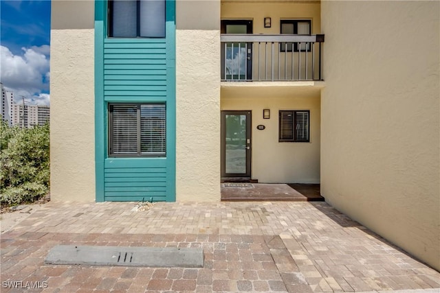 entrance to property with stucco siding