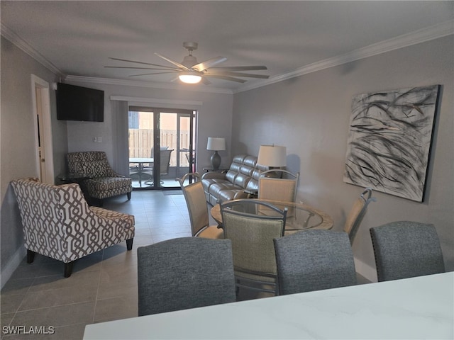 tiled living area featuring baseboards, ornamental molding, and a ceiling fan