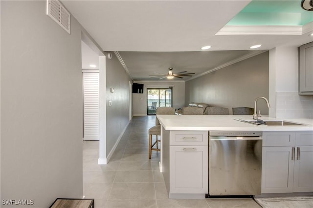 kitchen with visible vents, crown molding, dishwasher, gray cabinets, and a sink