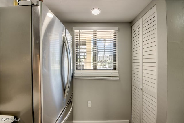 details with baseboards and freestanding refrigerator