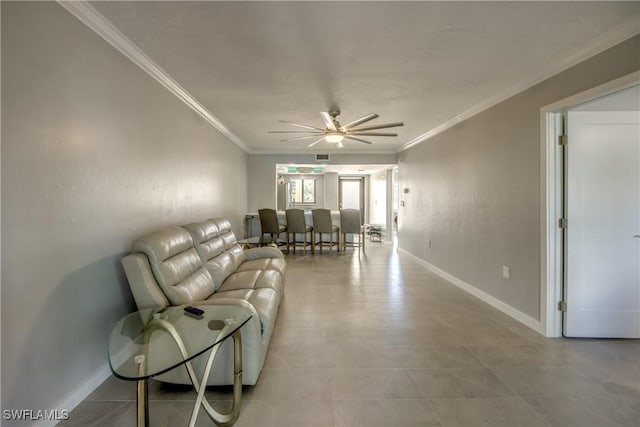 living room featuring ceiling fan, crown molding, and baseboards