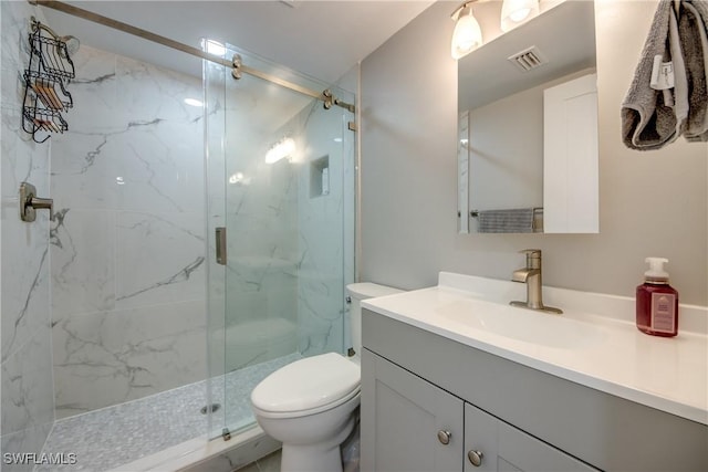 bathroom featuring a marble finish shower, visible vents, toilet, and vanity