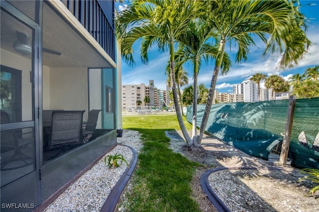 view of yard with a city view and fence