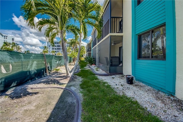 view of yard with a lanai and fence