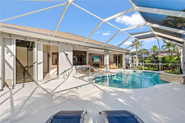 pool featuring a lanai and a patio area