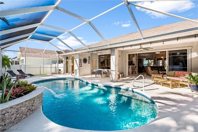 pool with glass enclosure, an outdoor hangout area, a ceiling fan, and a patio