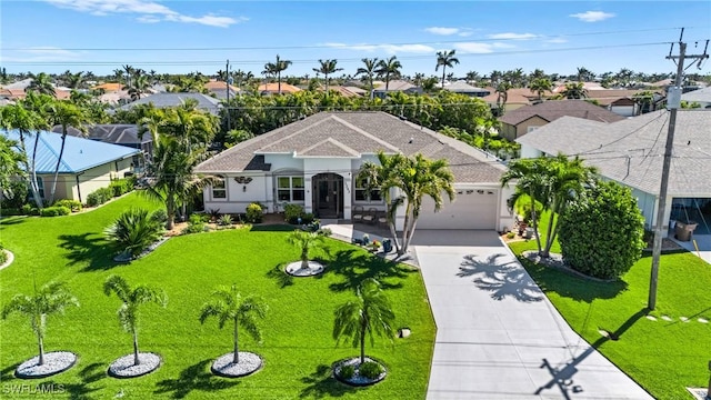 ranch-style house with concrete driveway, a garage, a front lawn, and a residential view