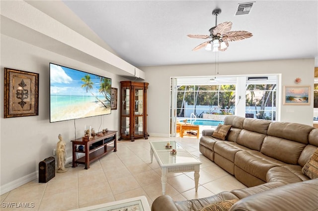 living area featuring visible vents, a ceiling fan, a sunroom, light tile patterned floors, and vaulted ceiling