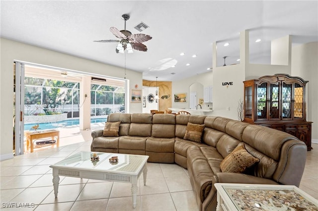 living area featuring a ceiling fan, visible vents, baseboards, light tile patterned flooring, and recessed lighting