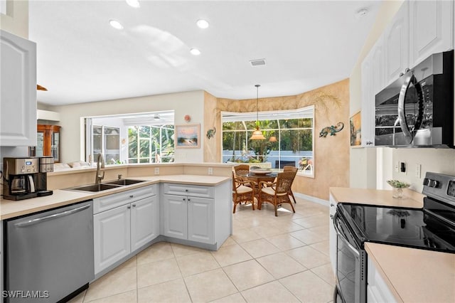 kitchen with visible vents, a sink, appliances with stainless steel finishes, a peninsula, and light countertops