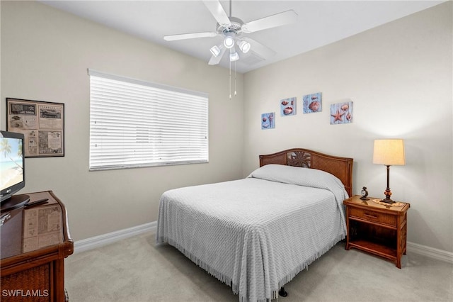 carpeted bedroom with a ceiling fan and baseboards