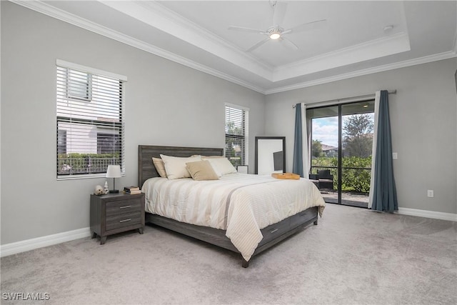 bedroom with light carpet, a raised ceiling, and access to outside