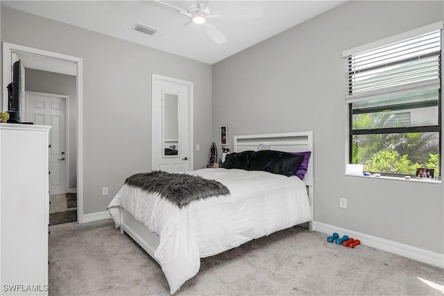 carpeted bedroom with visible vents, ceiling fan, and baseboards