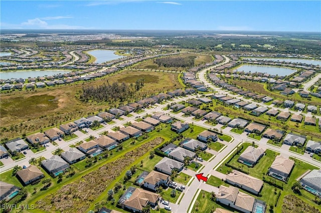 birds eye view of property featuring a residential view and a water view