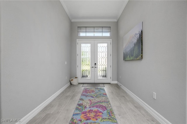 entryway with crown molding, french doors, and baseboards