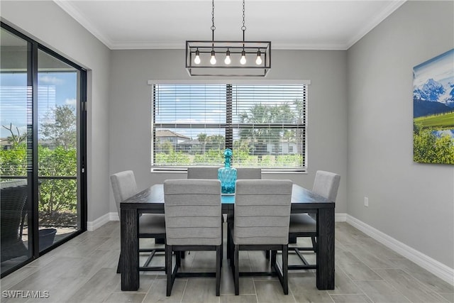 dining space featuring crown molding and baseboards